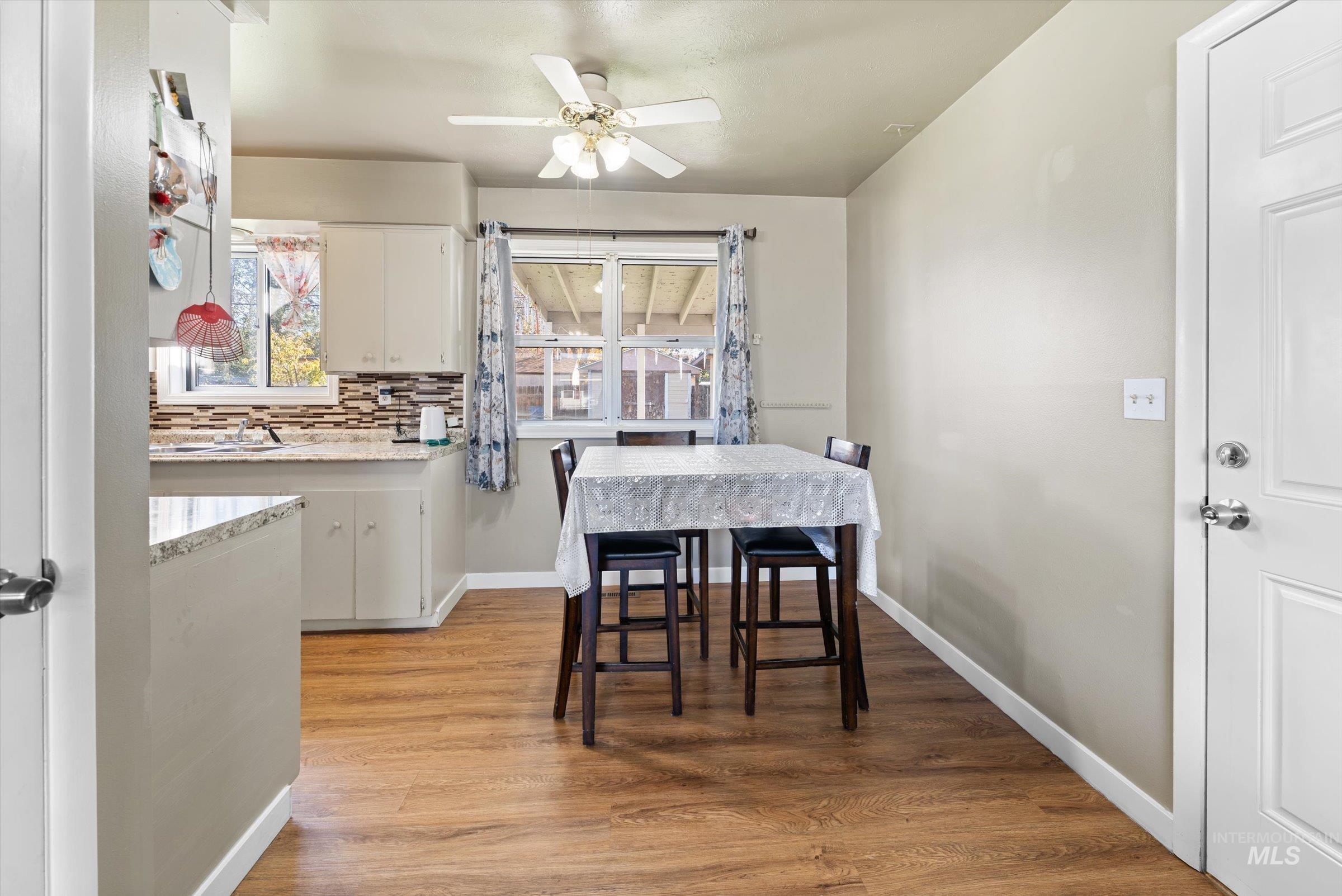 Dining space with light wood-type flooring and a ceiling fan