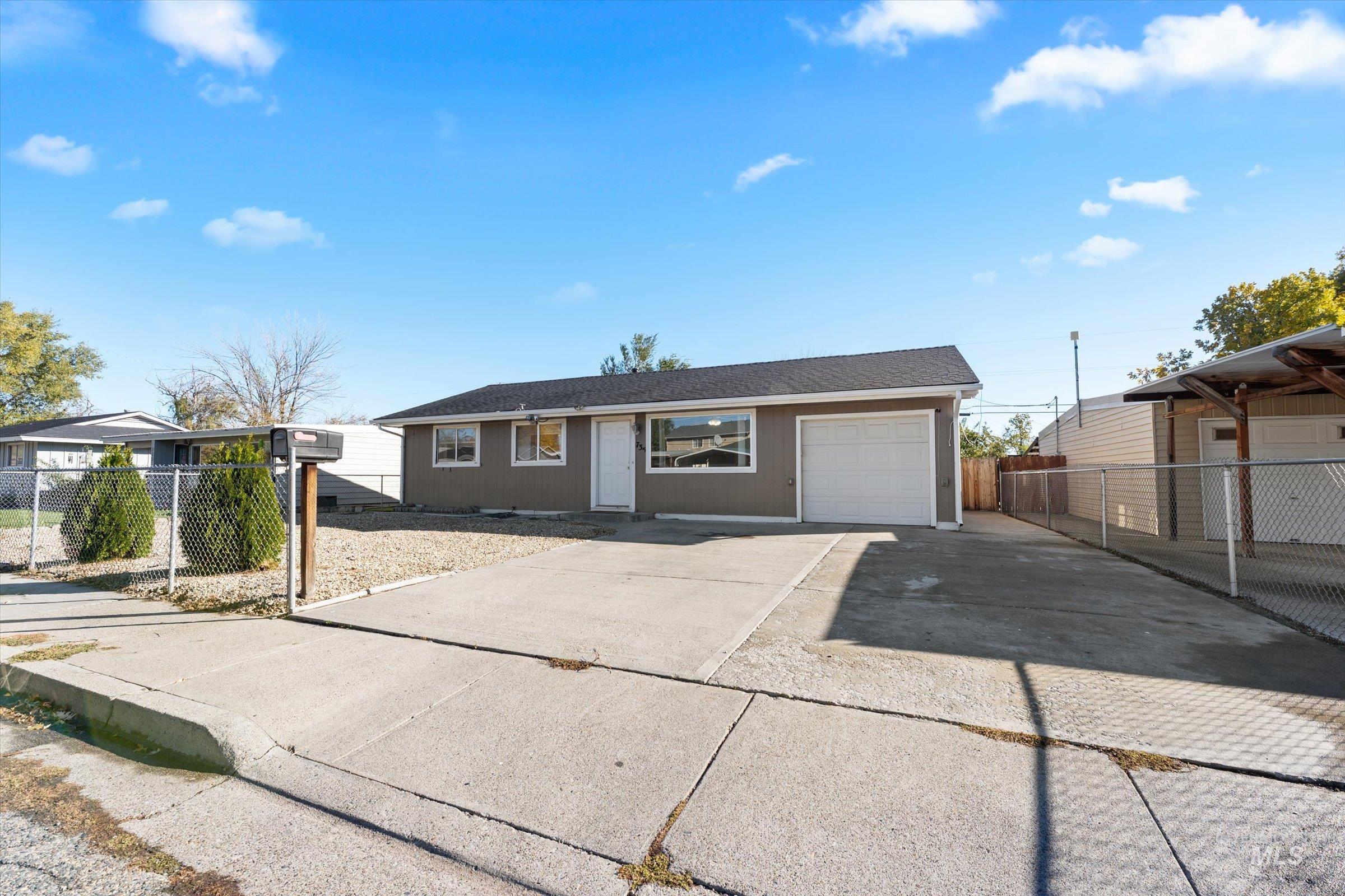 Ranch-style house with driveway and roof with shingles
