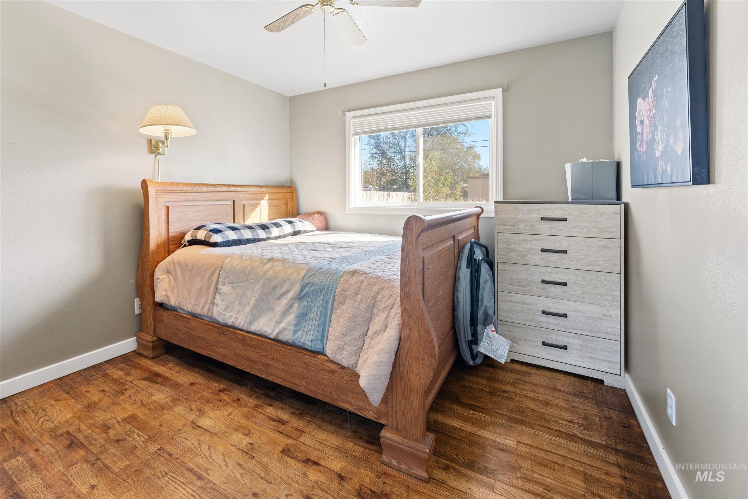 Bedroom featuring wood finished floors and a ceiling fan