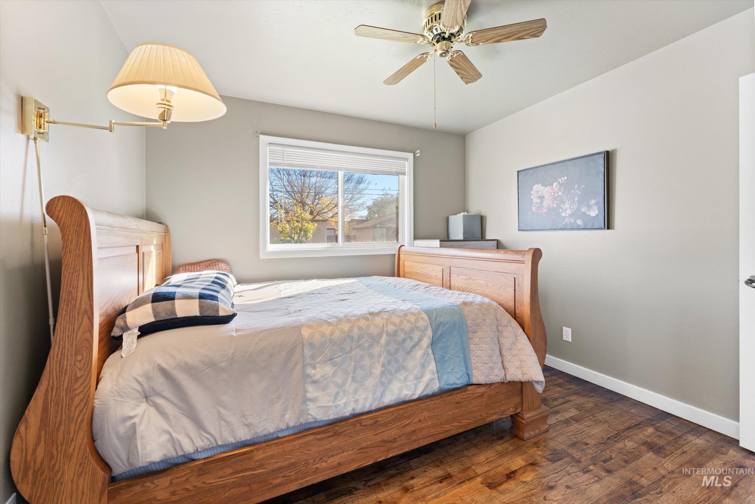 Bedroom featuring wood finished floors and ceiling fan