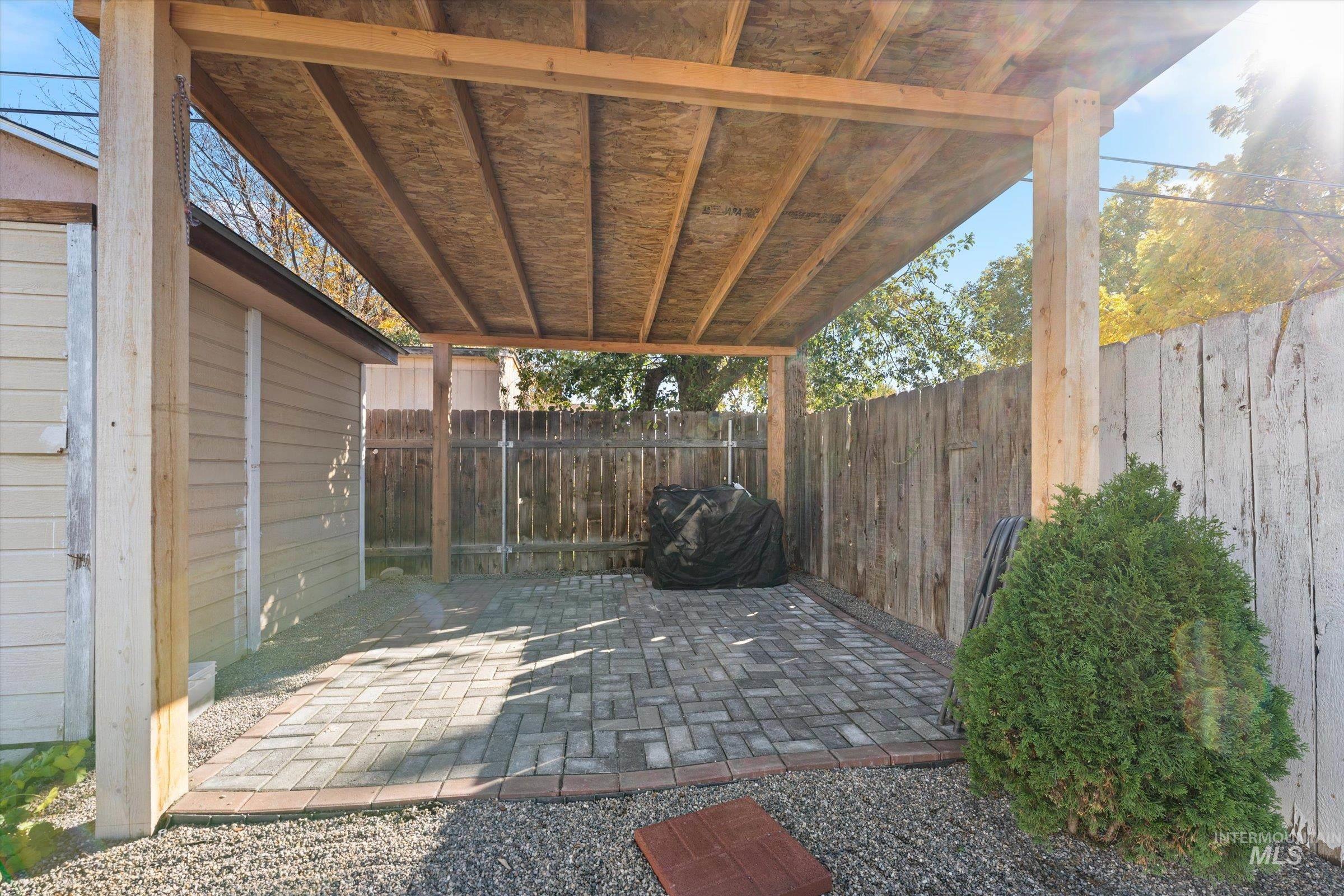 Fenced backyard featuring a patio area and grilling area