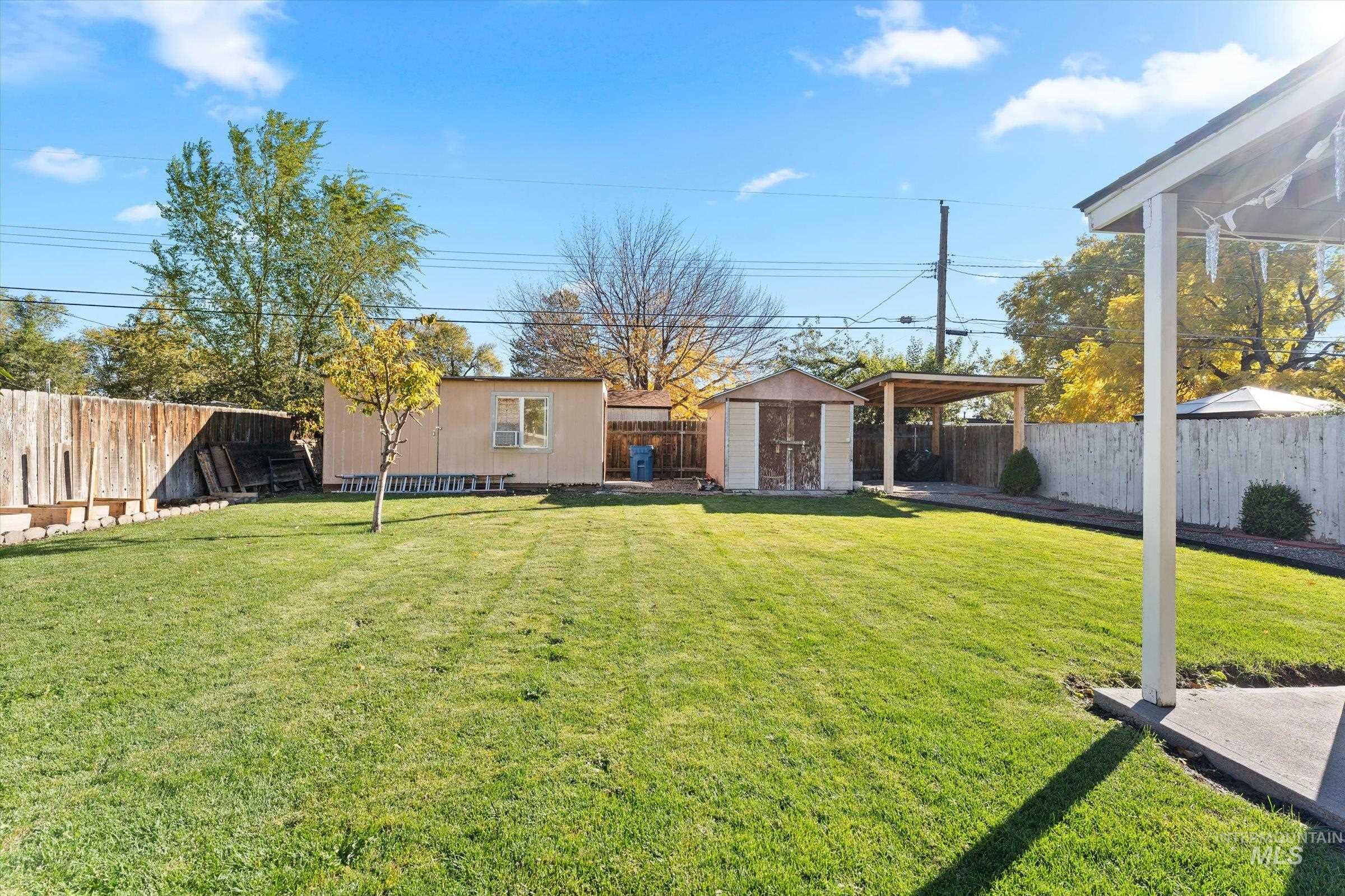 Fenced backyard with a storage unit