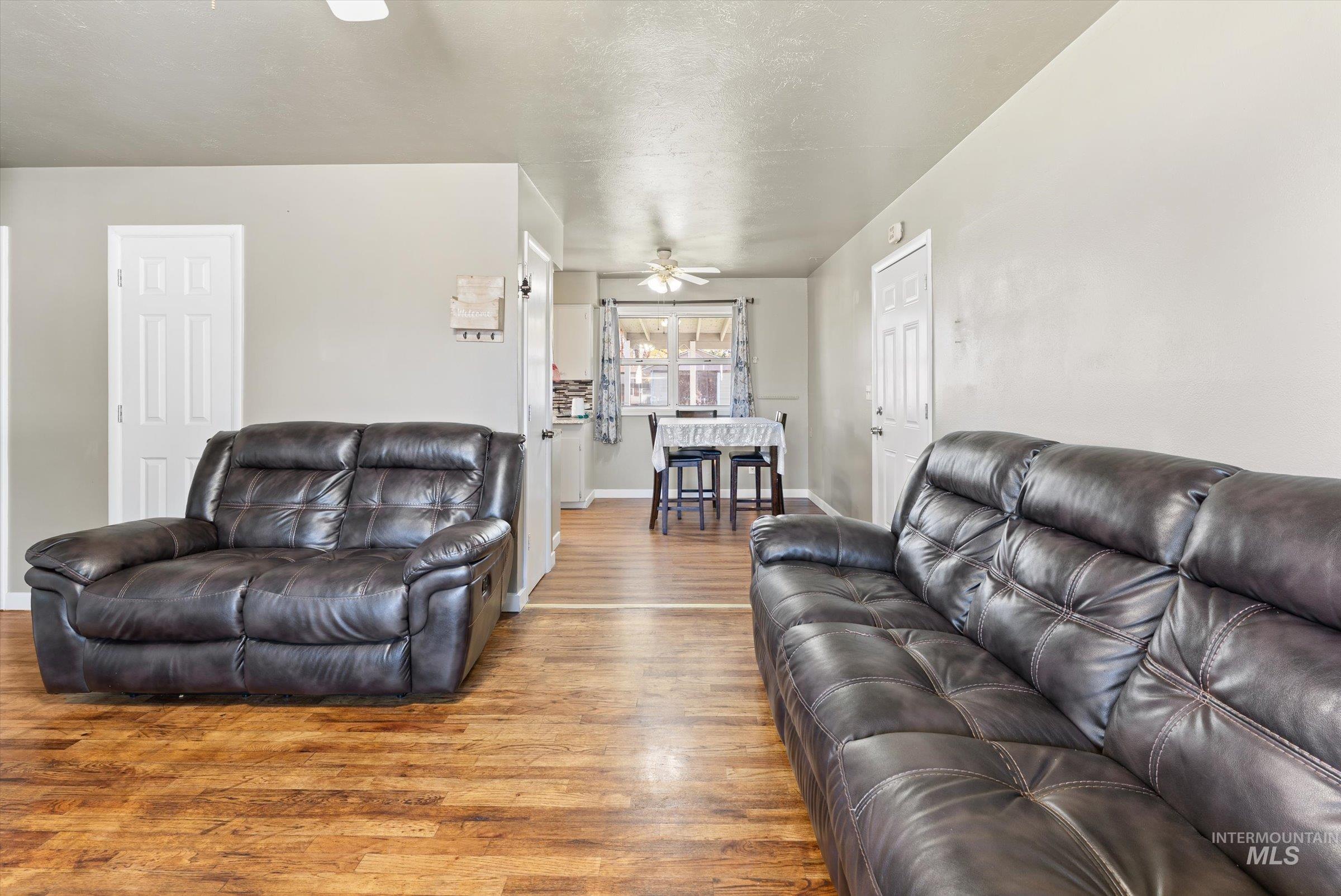 Living area featuring wood finished floors and a textured ceiling