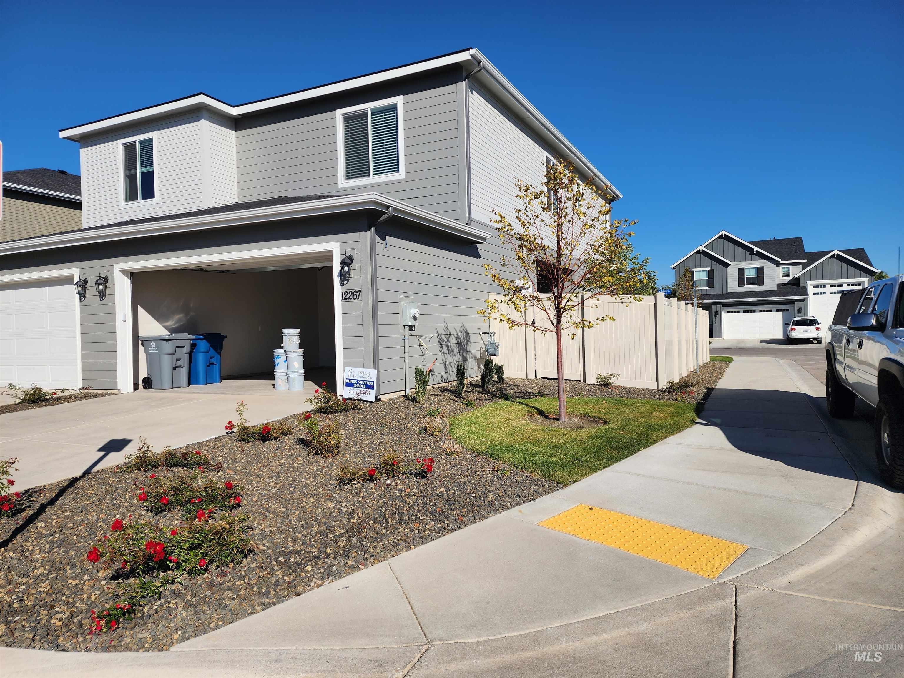 View of side of home with a garage and concrete driveway
