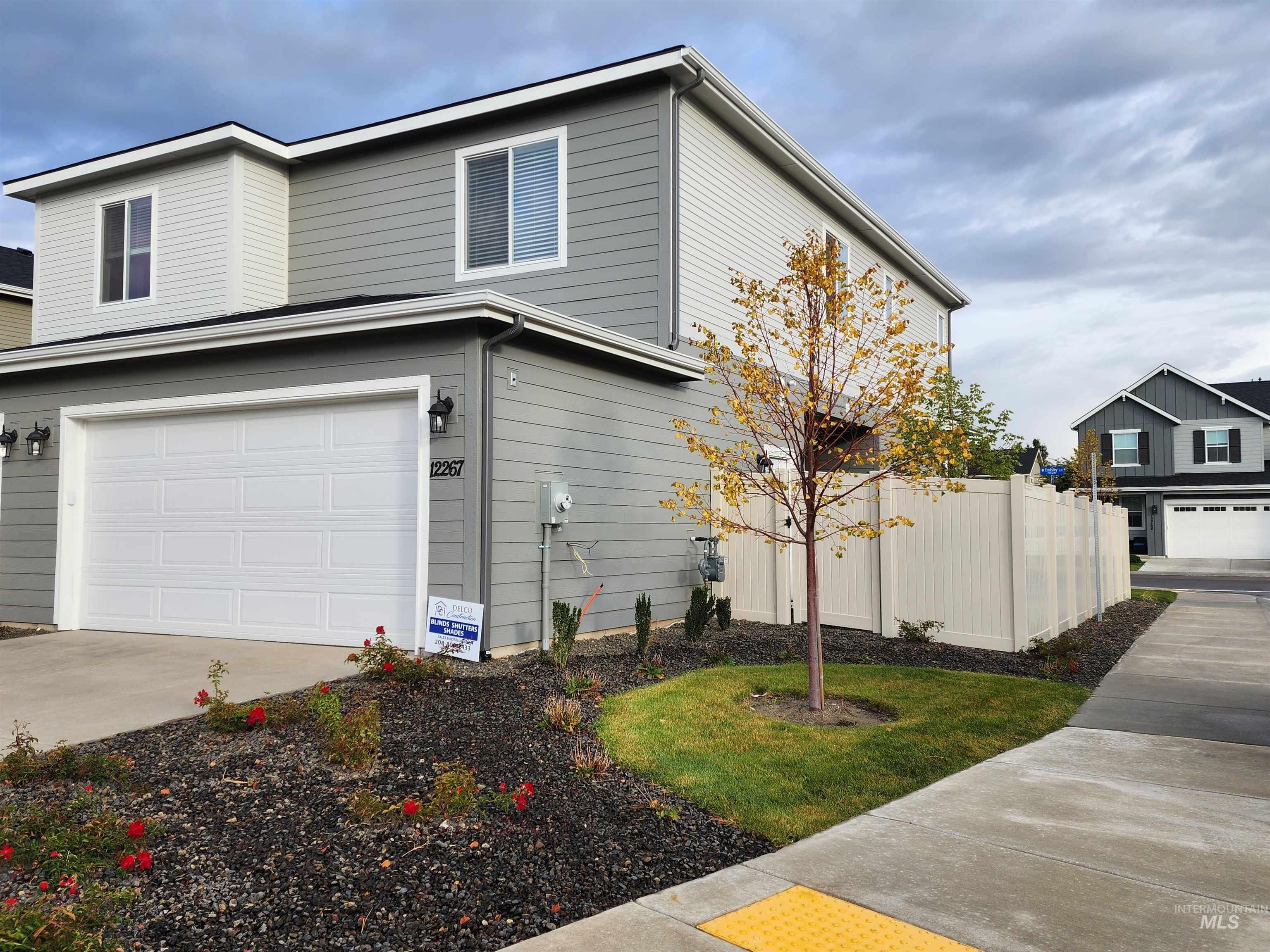 View of side of home with an attached garage and concrete driveway