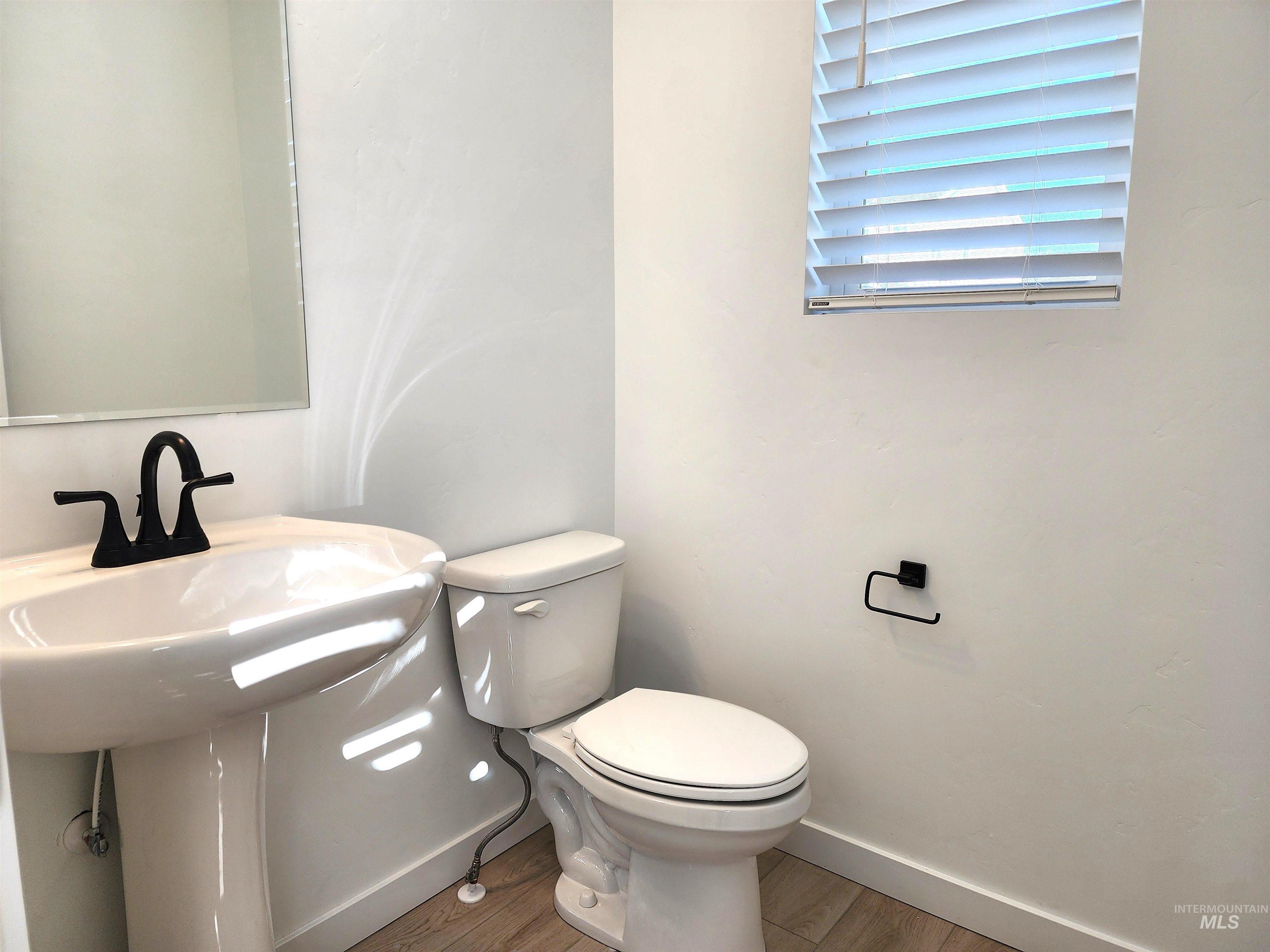 Bathroom featuring wood finished floors and baseboards