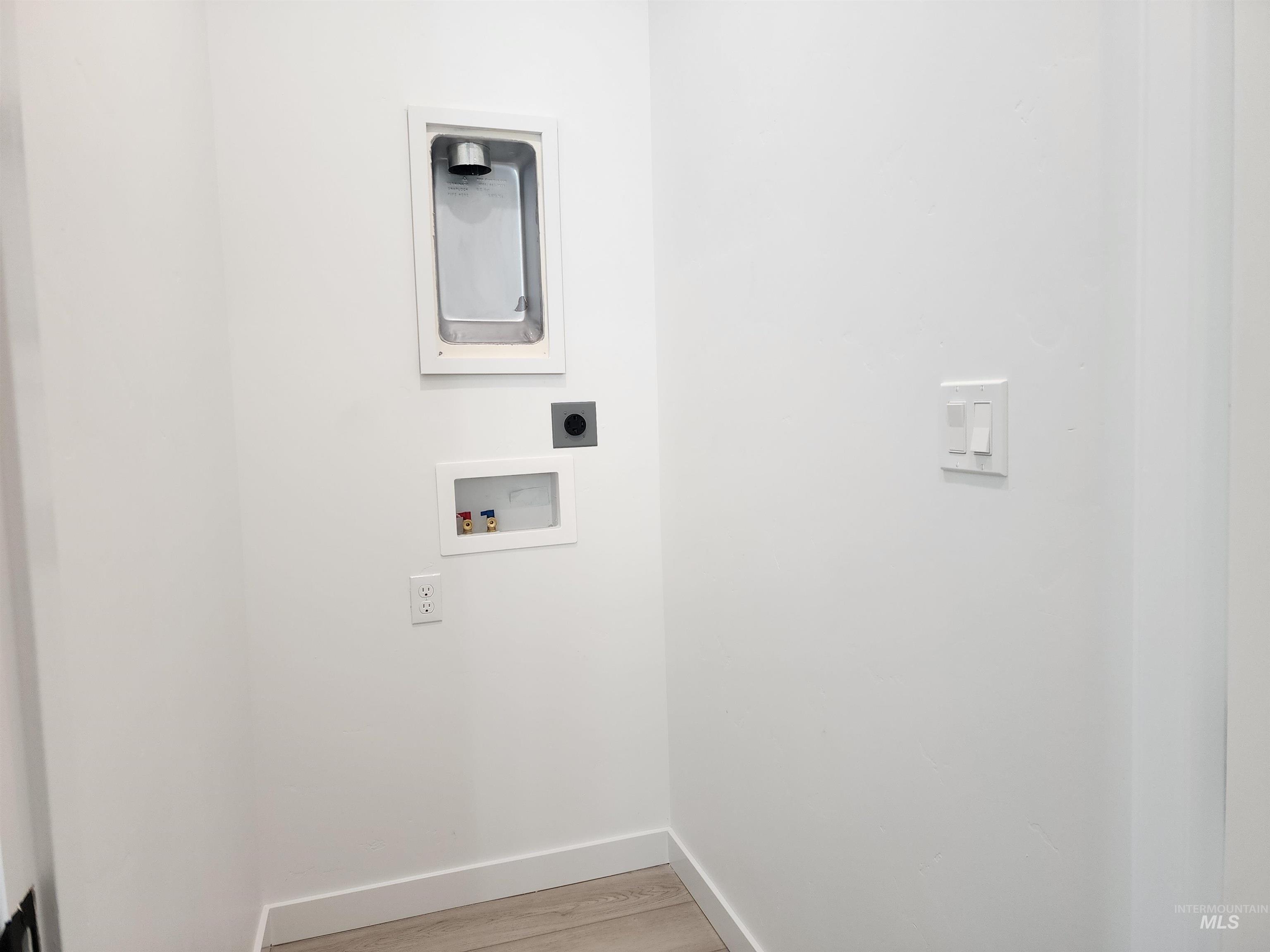 Laundry area featuring washer hookup, light wood-type flooring, and electric dryer hookup