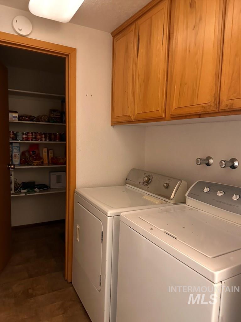 Laundry room with washing machine and clothes dryer and cabinet space