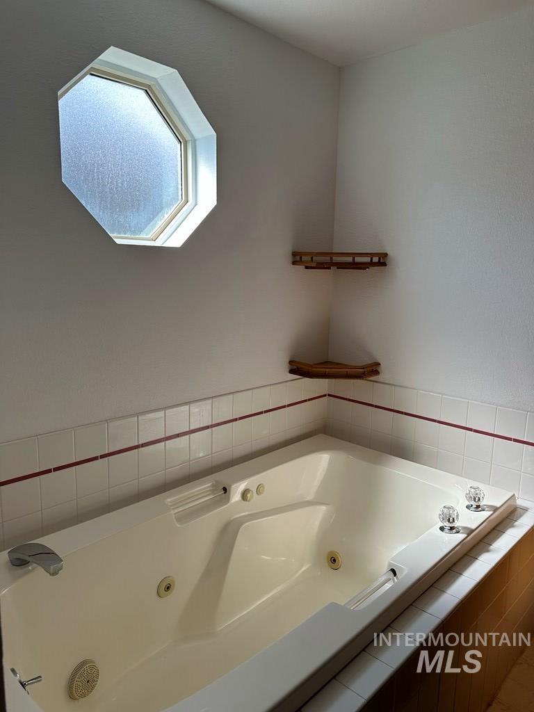 Full bath featuring a tub with jets