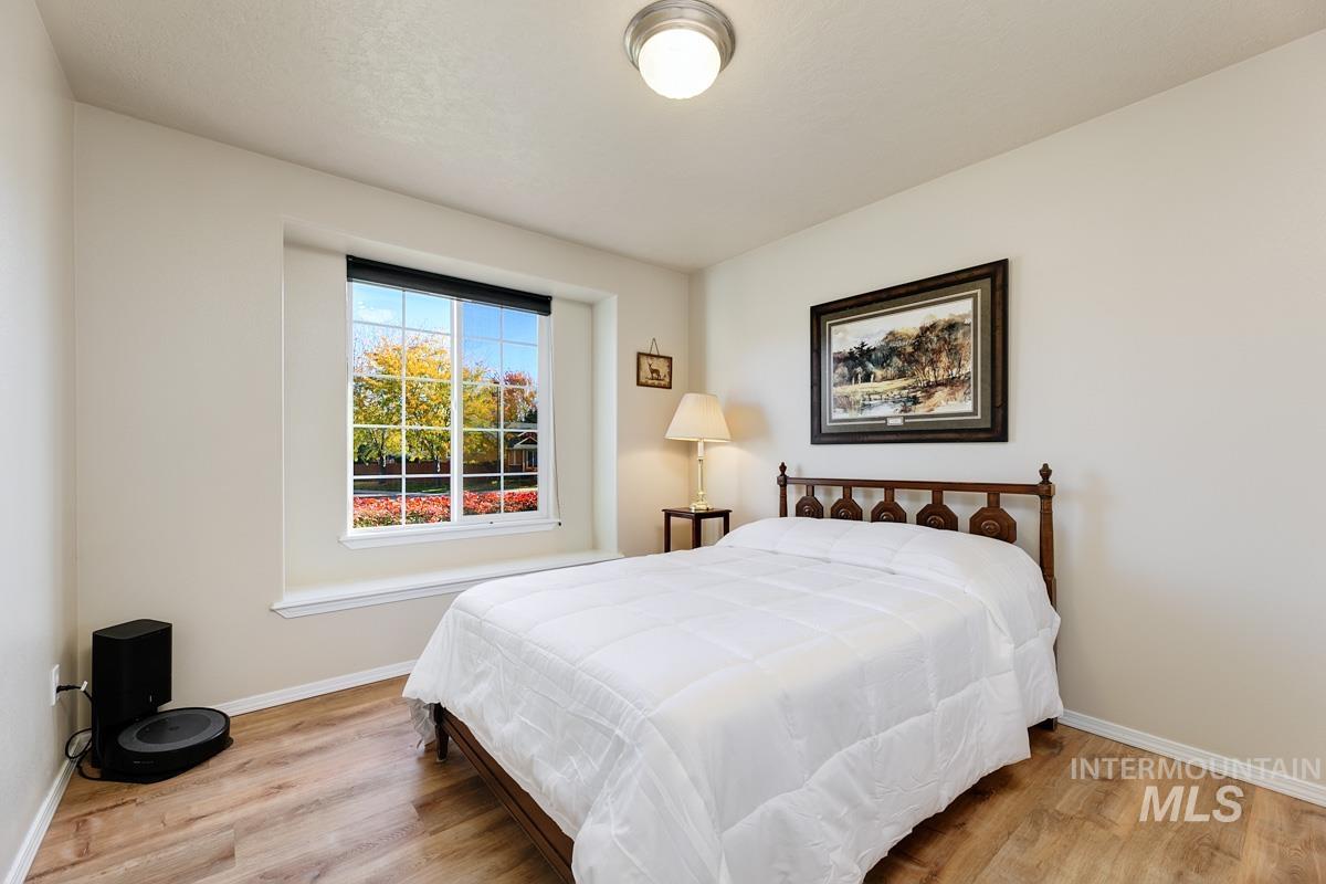 Bedroom featuring light wood-style floors and baseboards