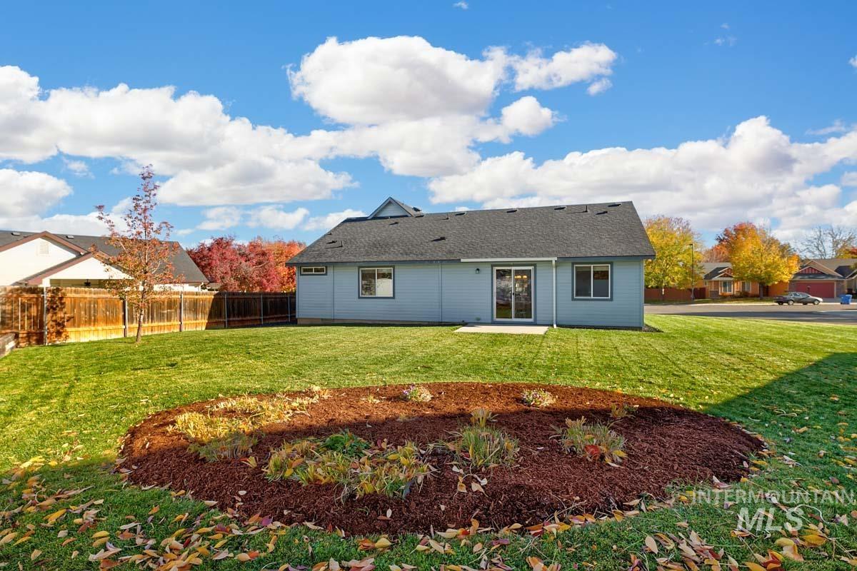 Rear view of property featuring a patio area and a fenced backyard