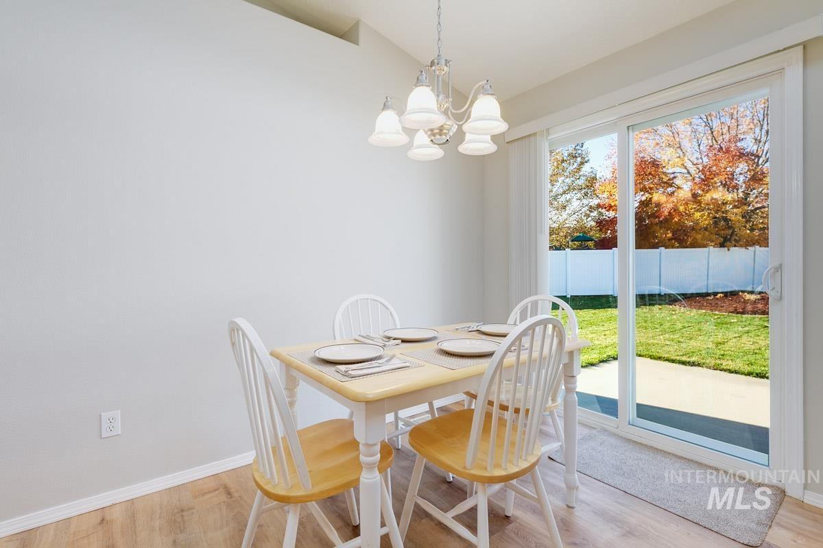 Dining space with light wood-style flooring and a chandelier