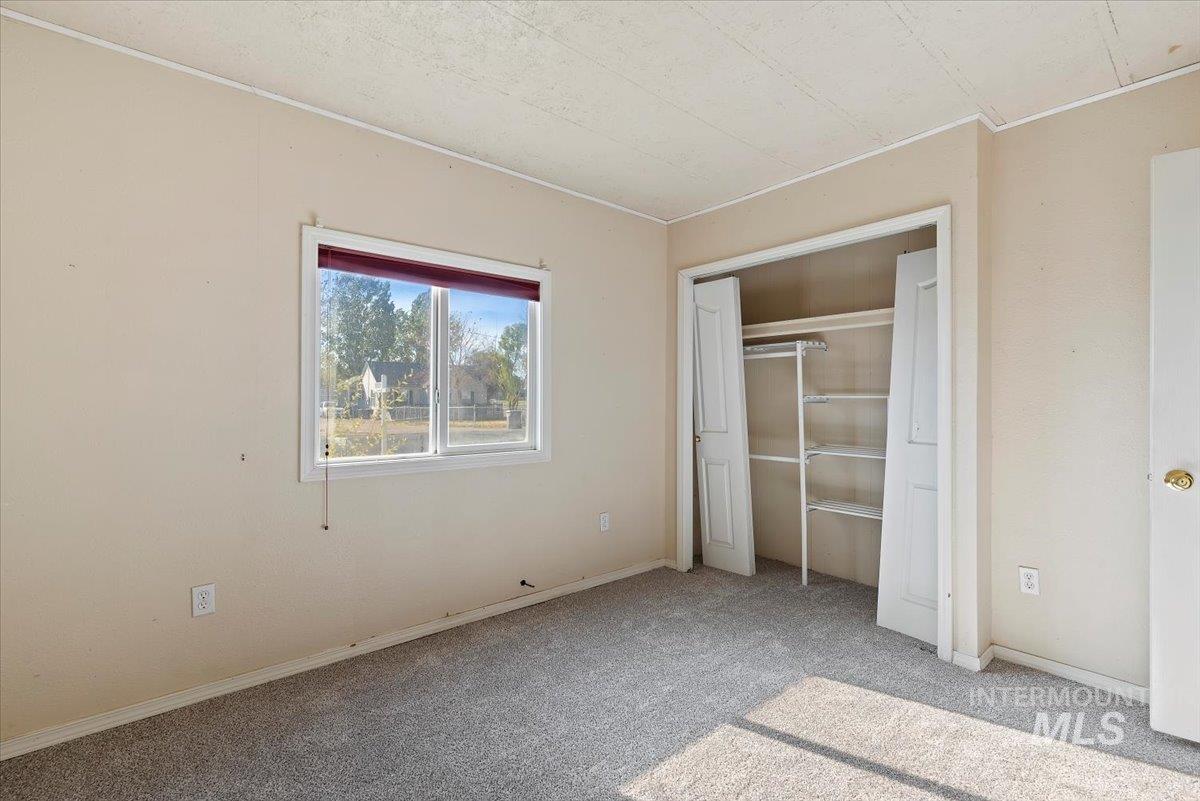 Unfurnished bedroom featuring carpet flooring and a closet