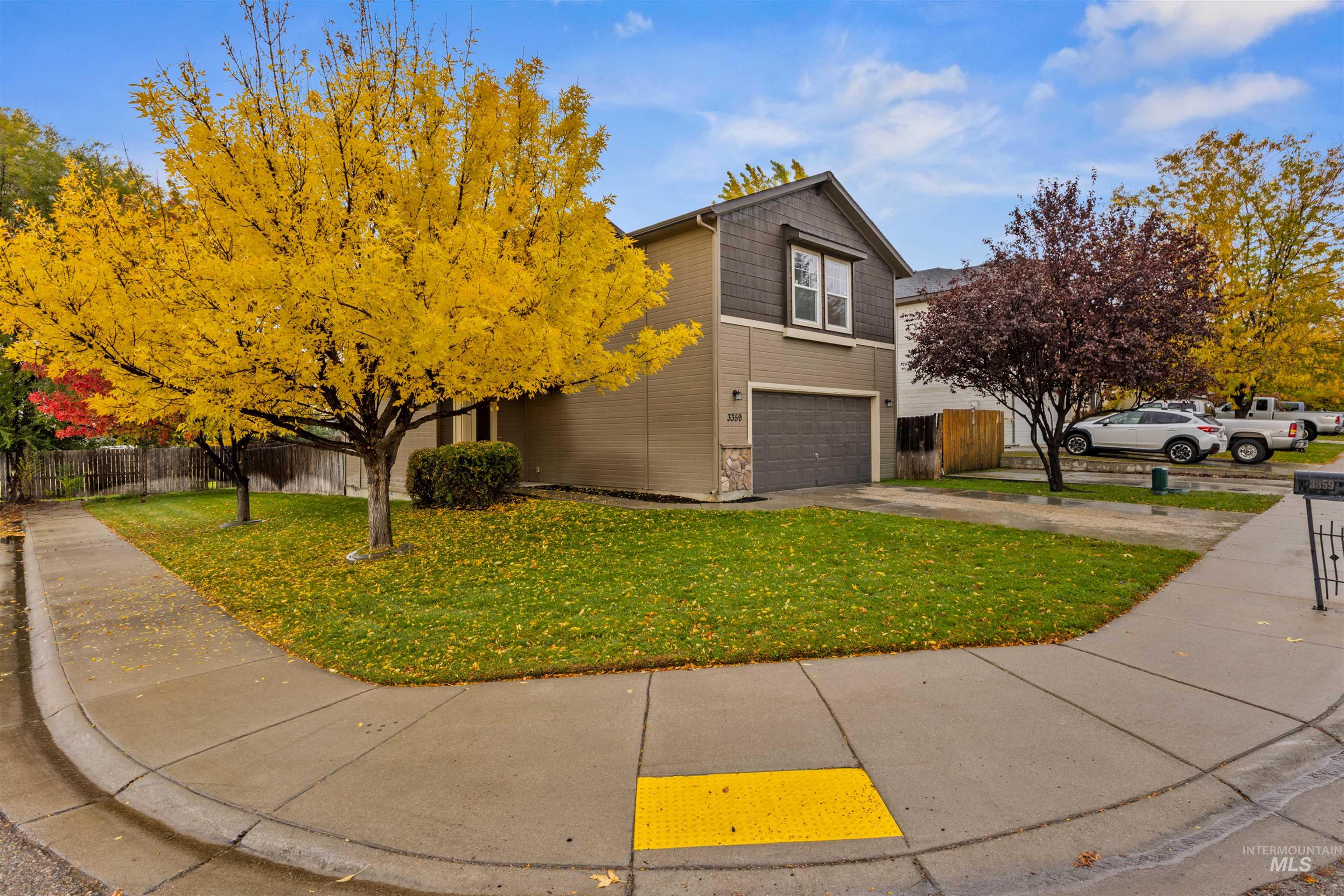 View of front of home with driveway and a garage
