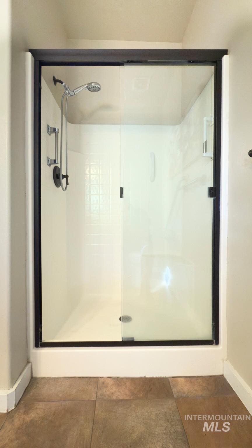 Full bathroom featuring a stall shower