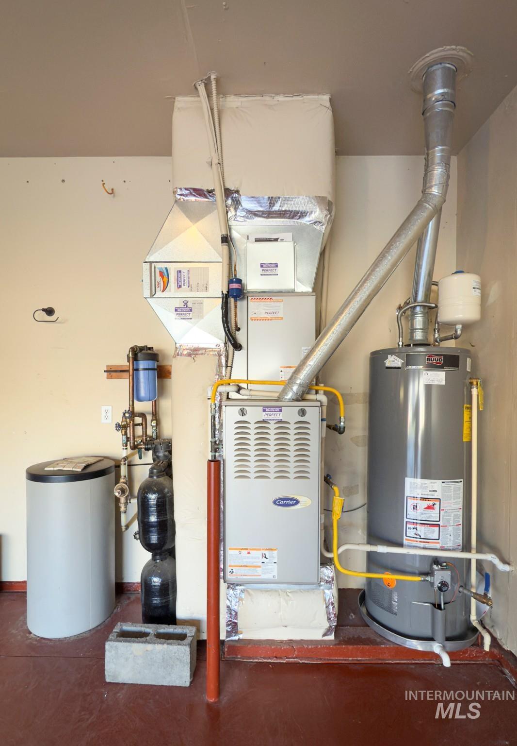 Utility room with gas water heater and heating unit