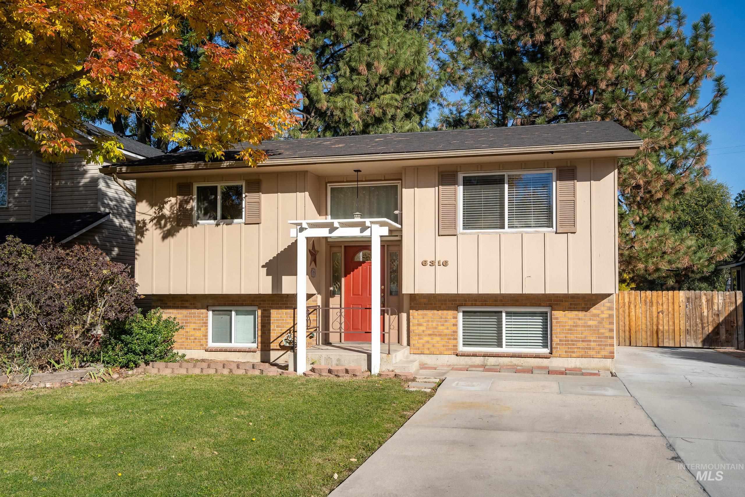 Raised ranch with brick siding and board and batten siding