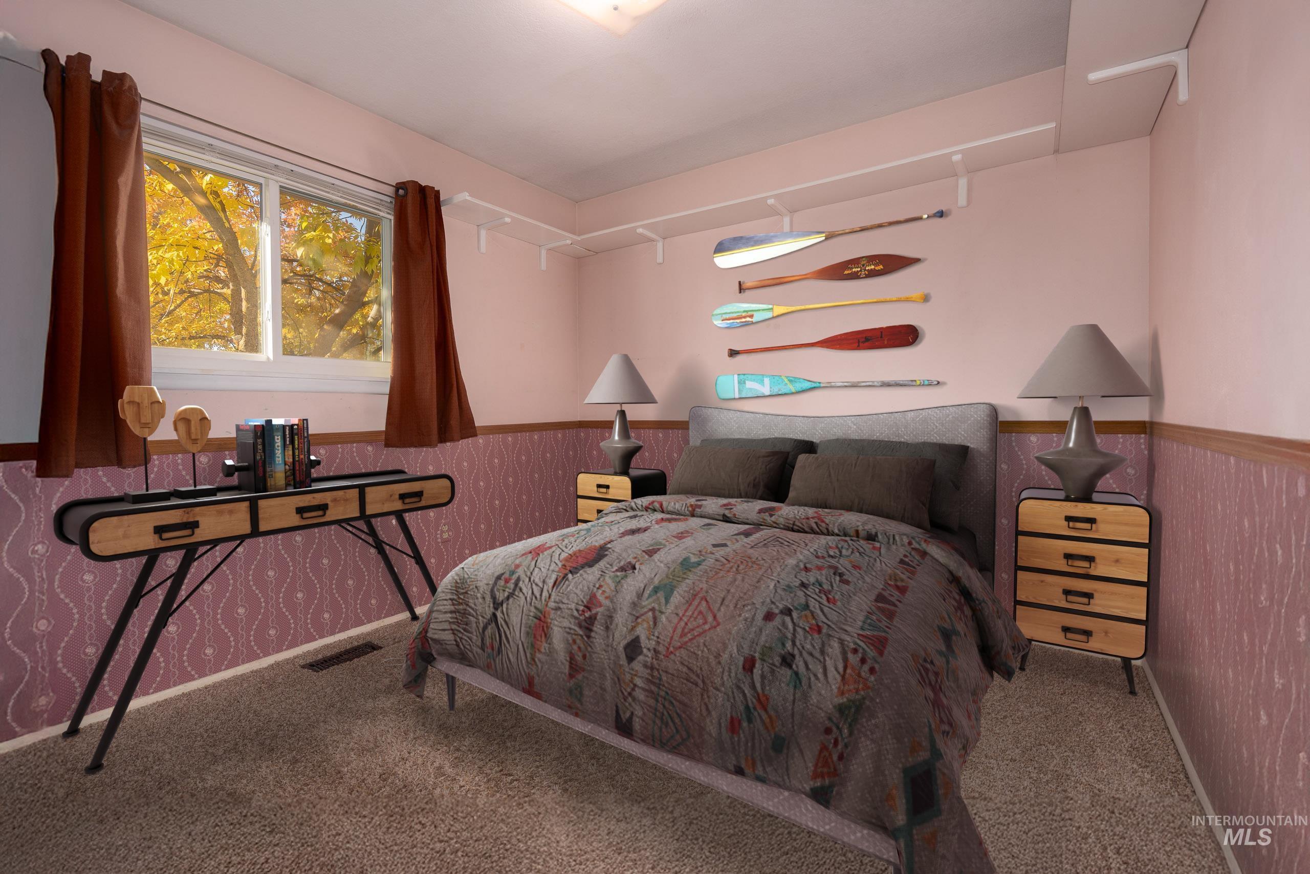 Carpeted bedroom with wainscoting and rail lighting