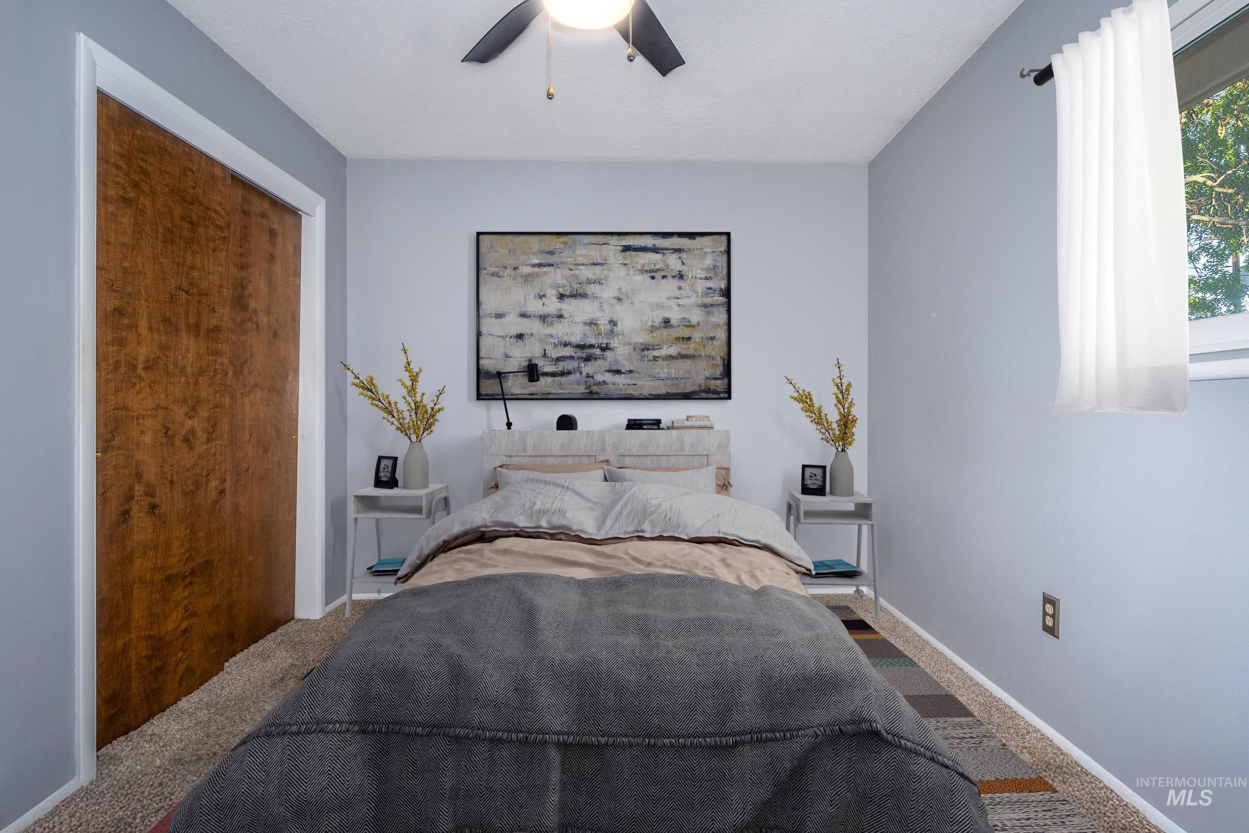 Carpeted bedroom with baseboards and a ceiling fan