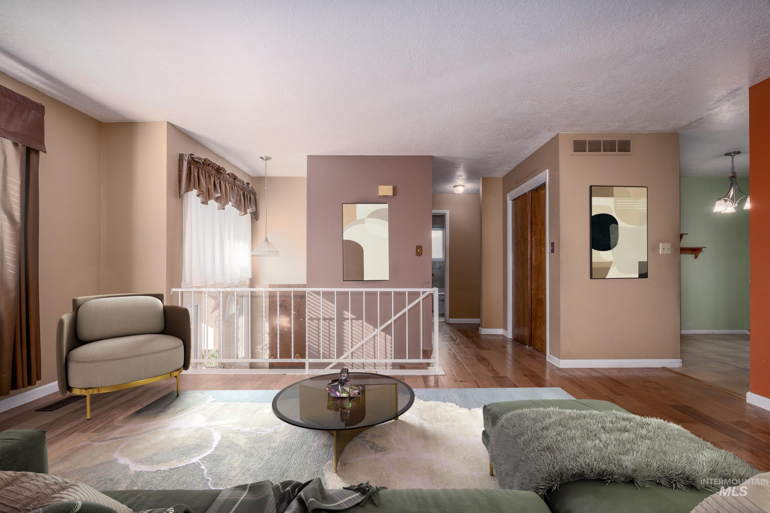 Living area with wood finished floors and a chandelier