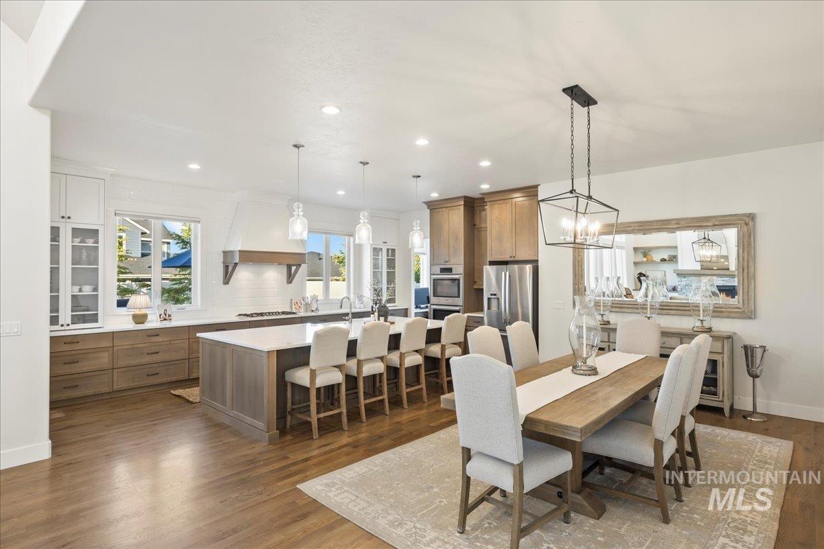 Dining room with wood finished floors, recessed lighting, and a chandelier