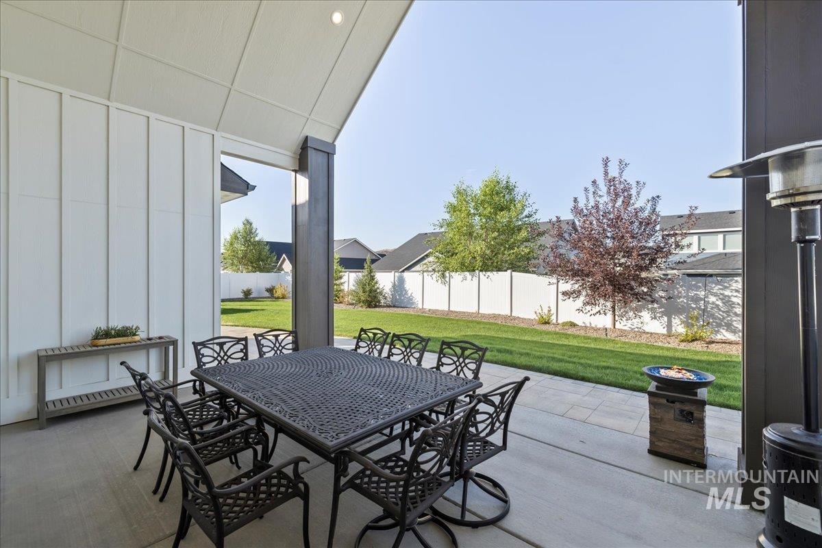Fenced backyard featuring outdoor dining space and a patio area