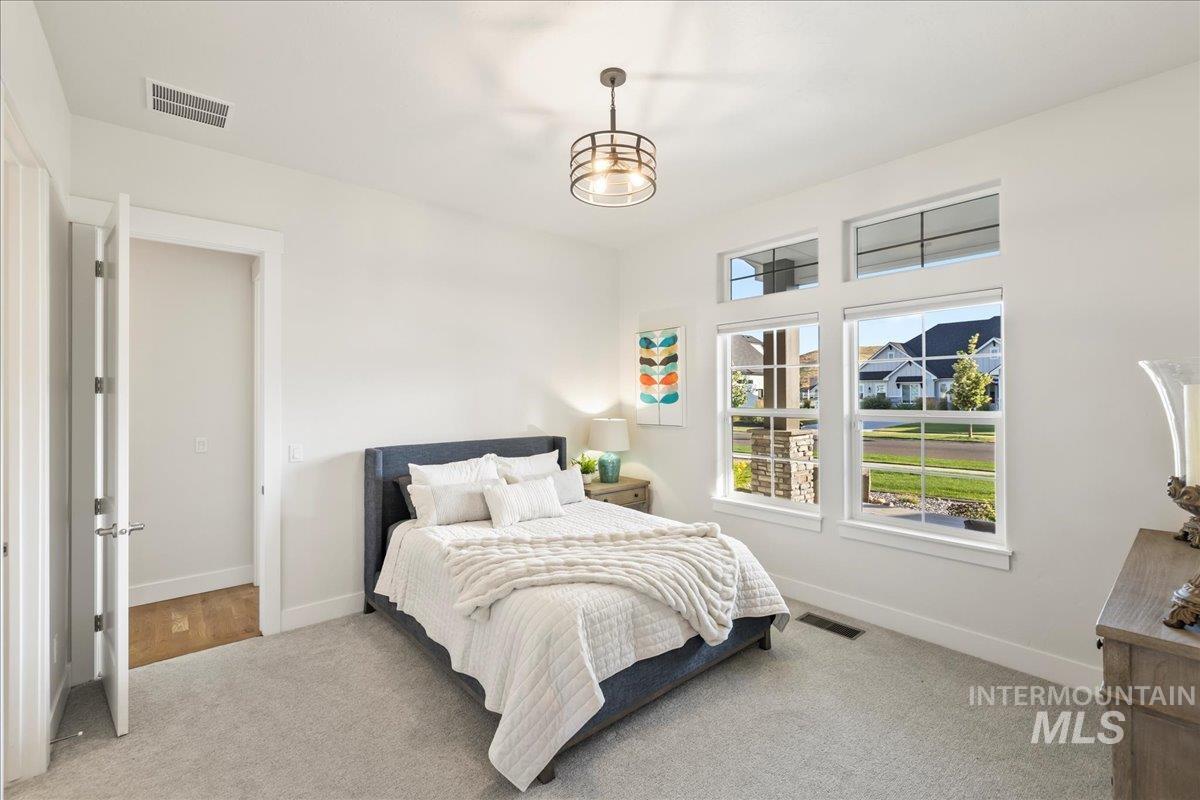 Carpeted bedroom featuring baseboards