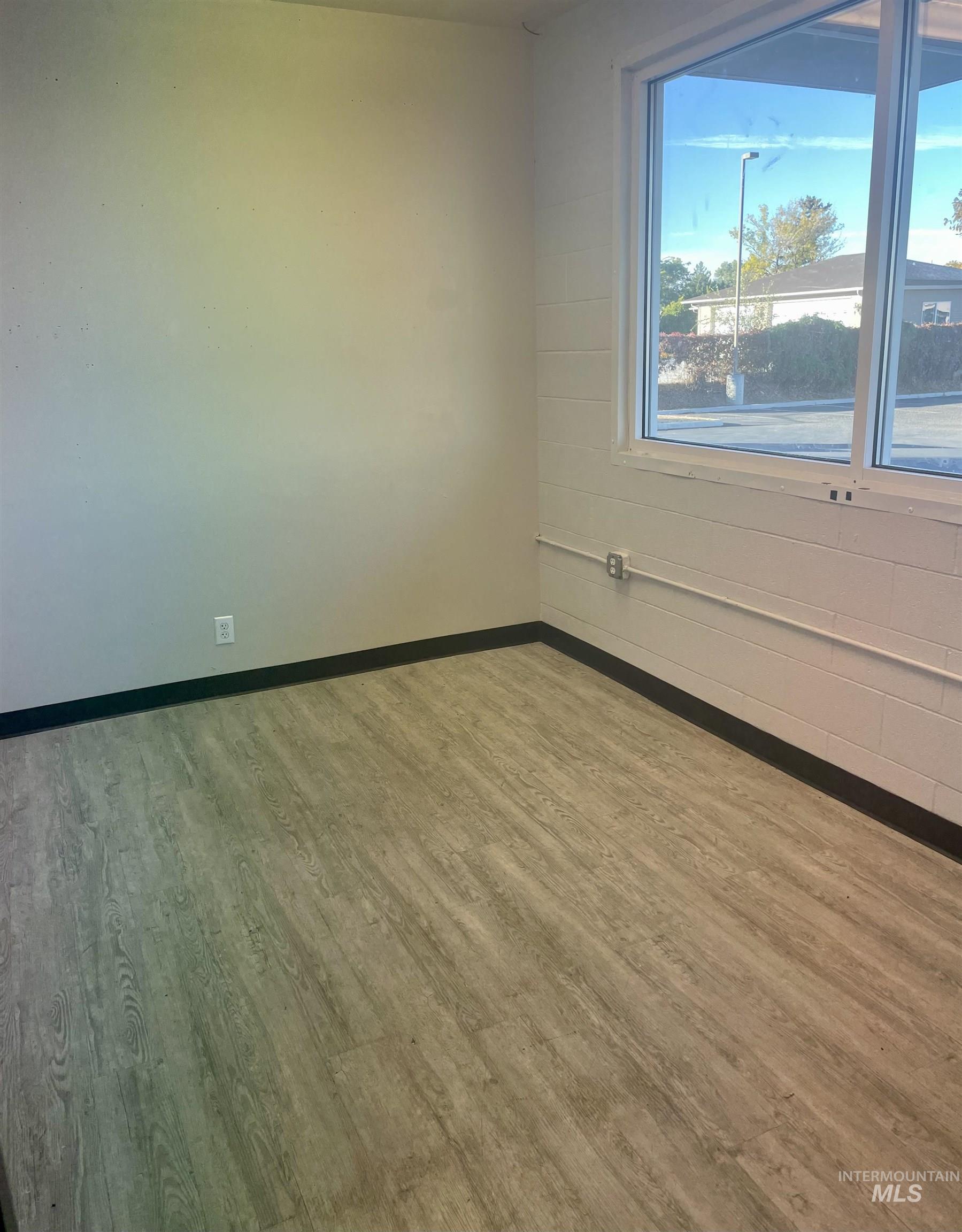 Unfurnished room featuring light wood-type flooring