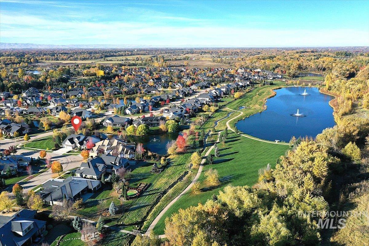 Aerial overview of property's location with a large body of water and nearby suburban area