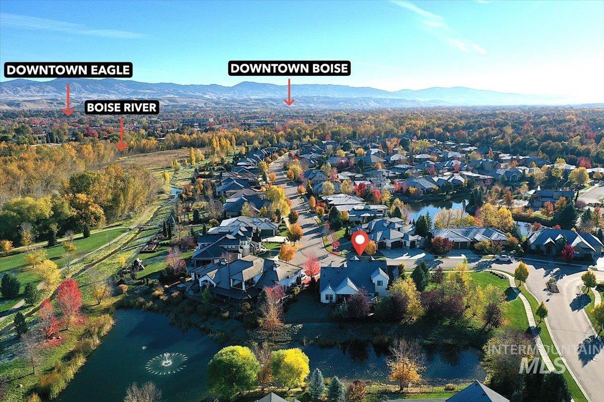 Aerial view of property's location featuring nearby suburban area and mountains