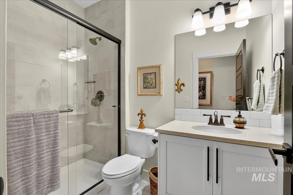 Full bathroom with vanity and a stall shower