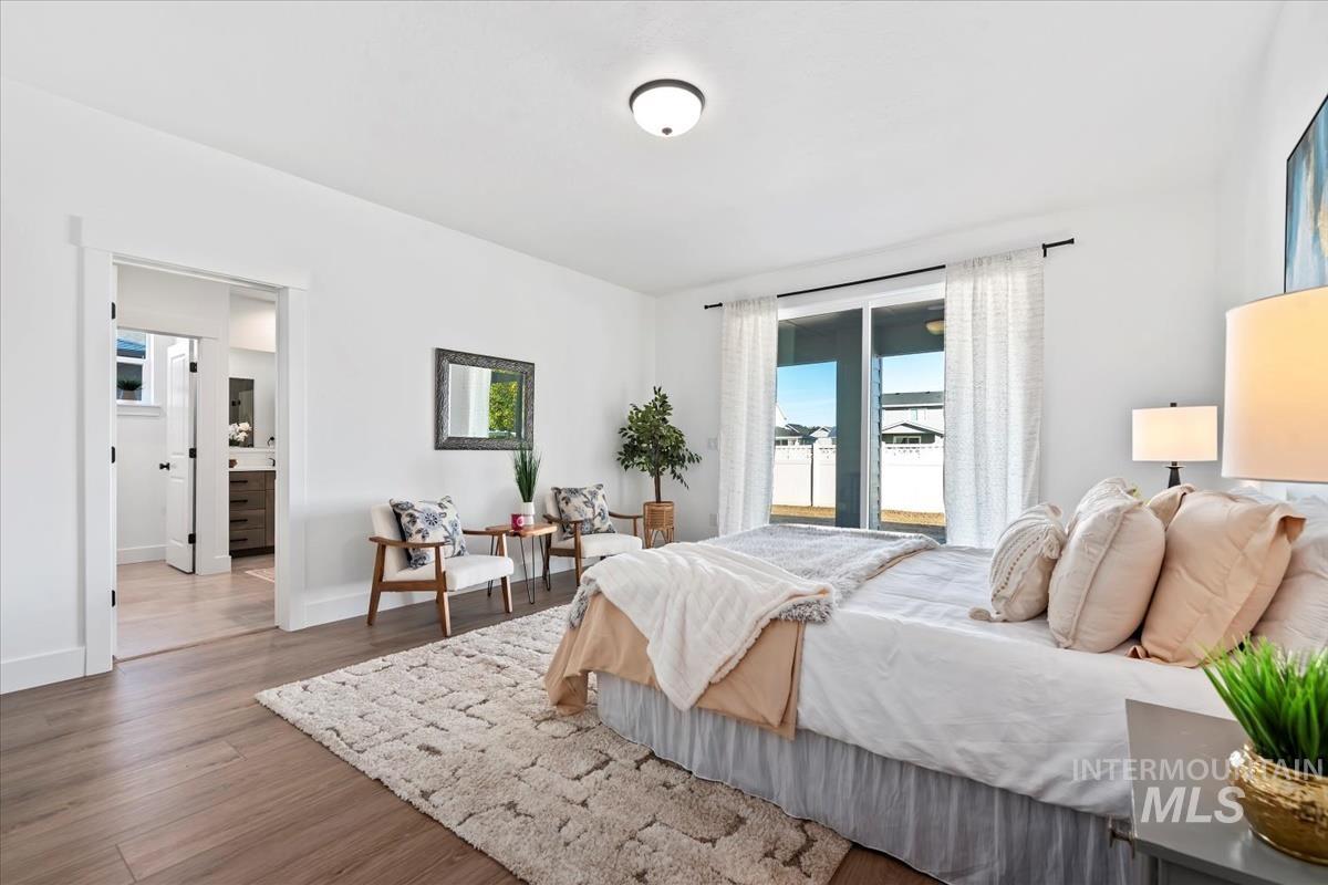 Bedroom featuring wood finished floors and baseboards