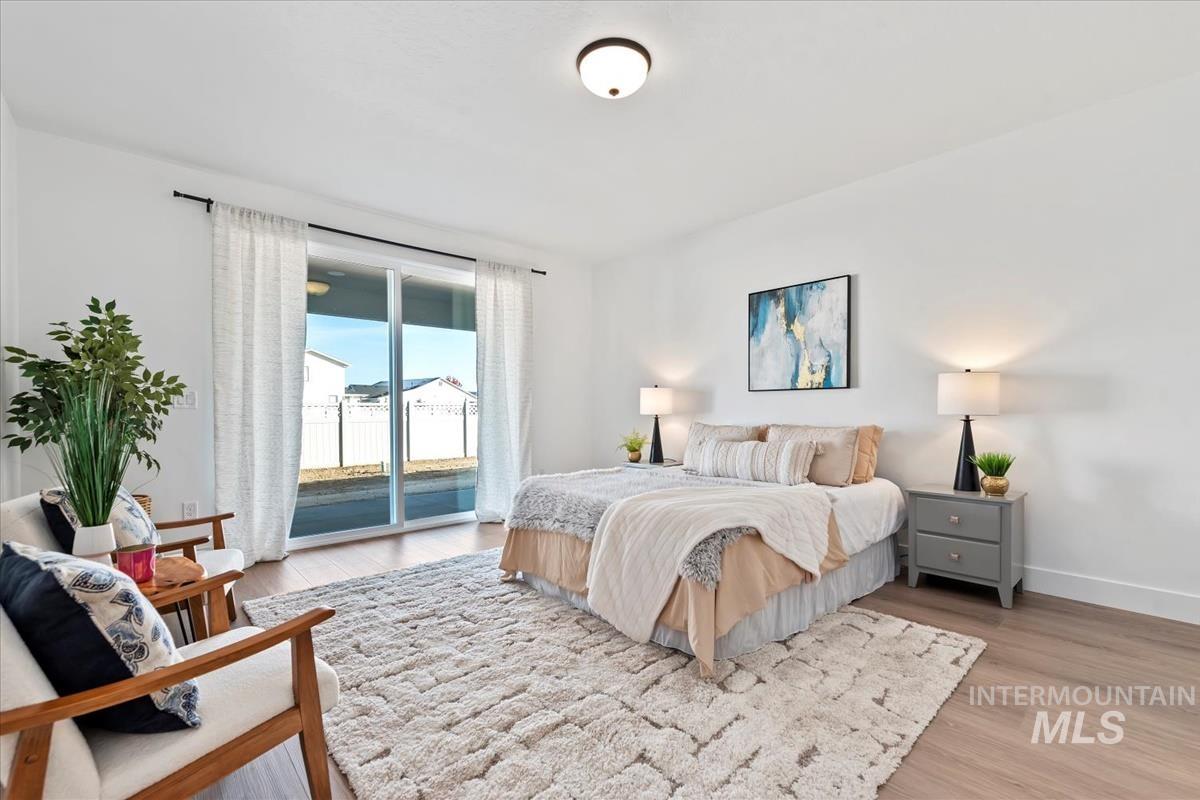 Bedroom with access to outside and light wood-style flooring