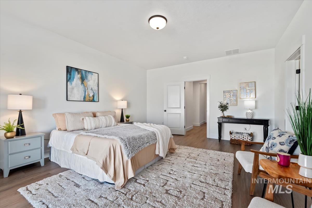 Bedroom featuring wood finished floors and baseboards