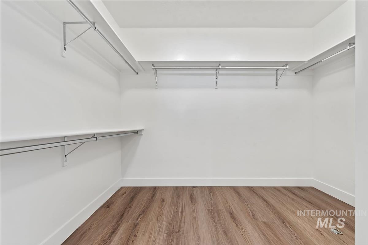 Spacious closet with light wood-style floors