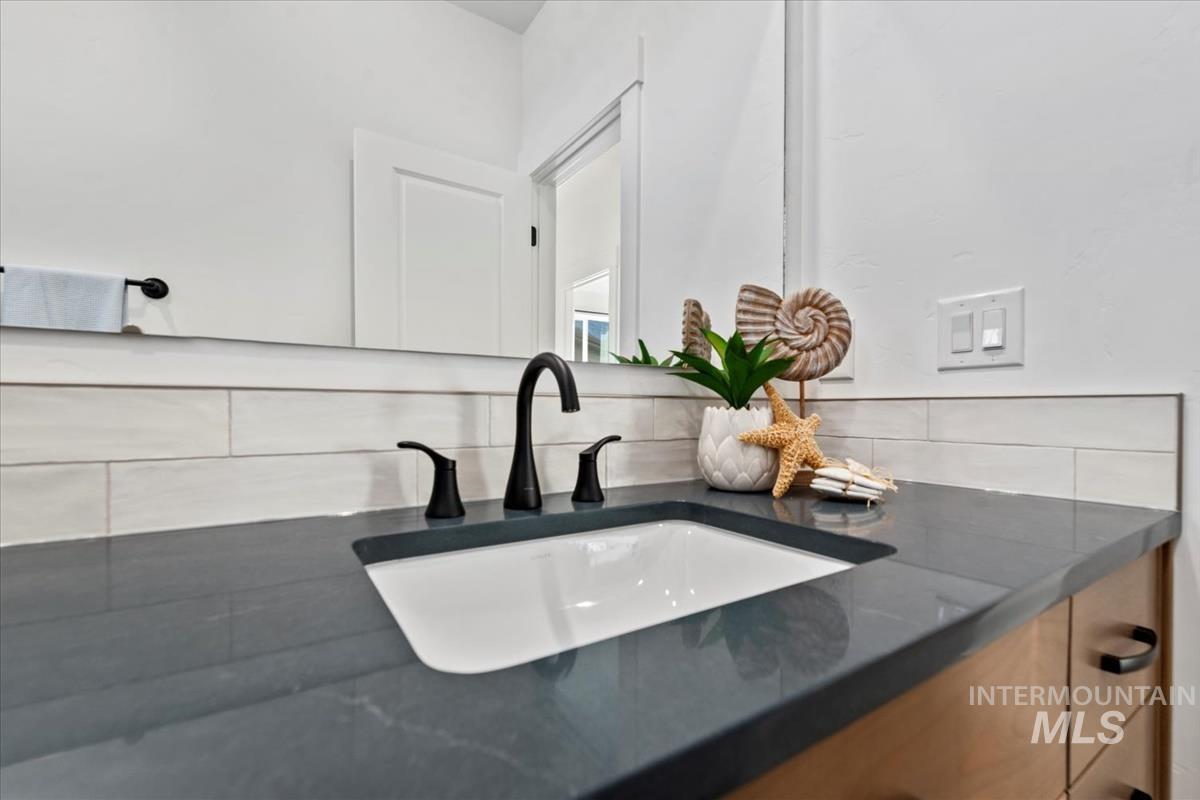 Bathroom view of tasteful backsplash and vanity