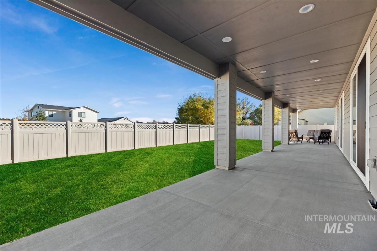 Fenced backyard with a patio area
