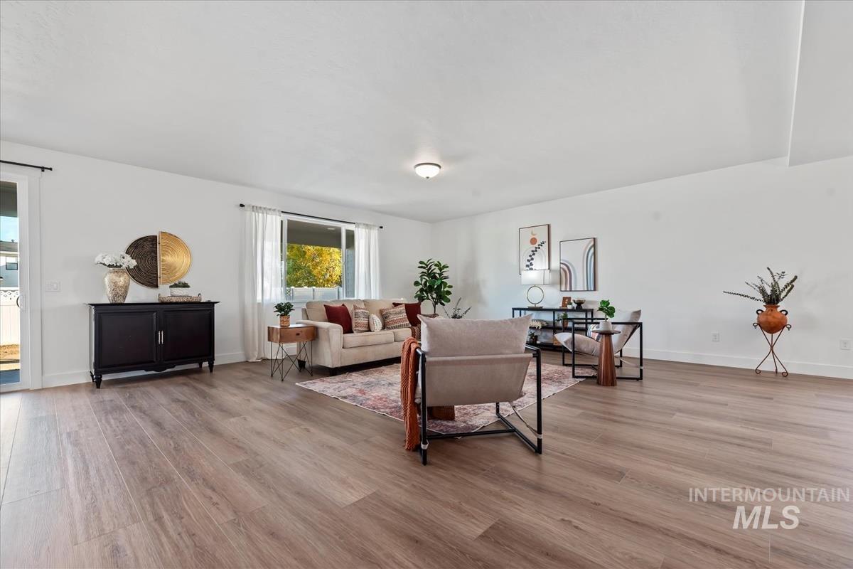 Living room with light wood-style floors and baseboards