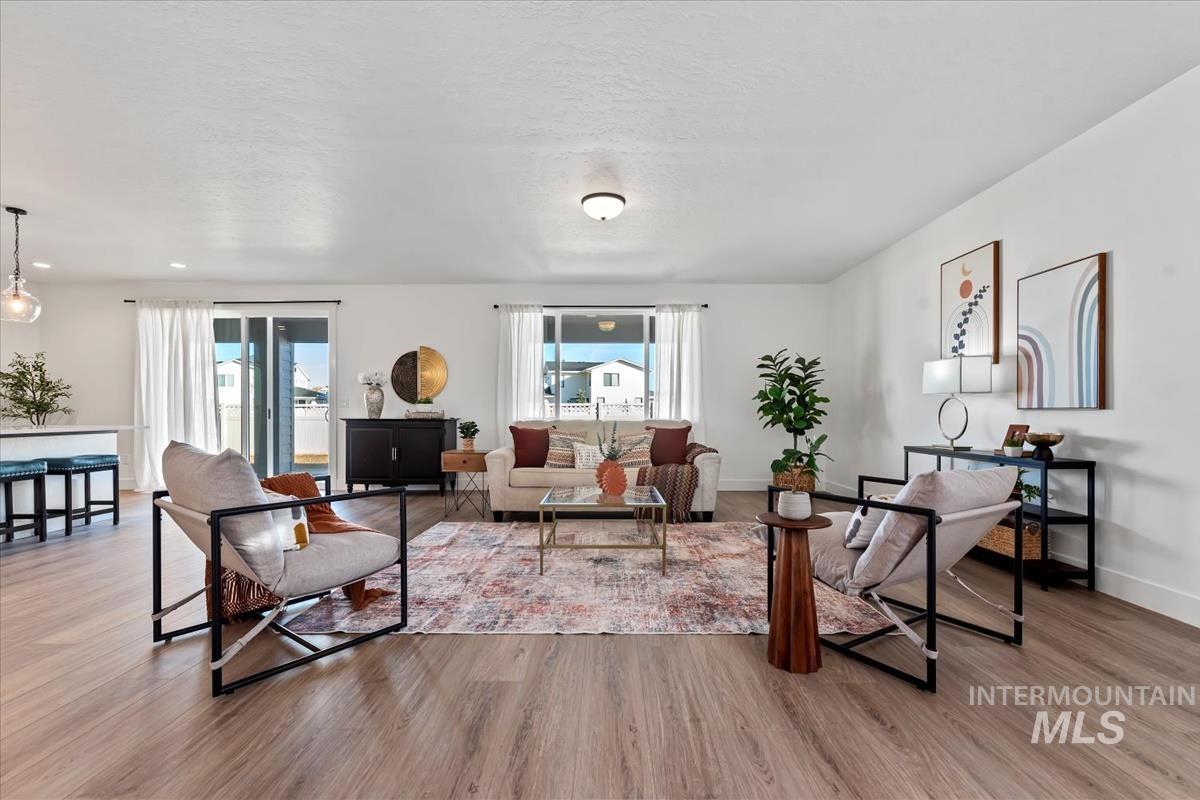 Living room featuring light wood-style floors and a textured ceiling