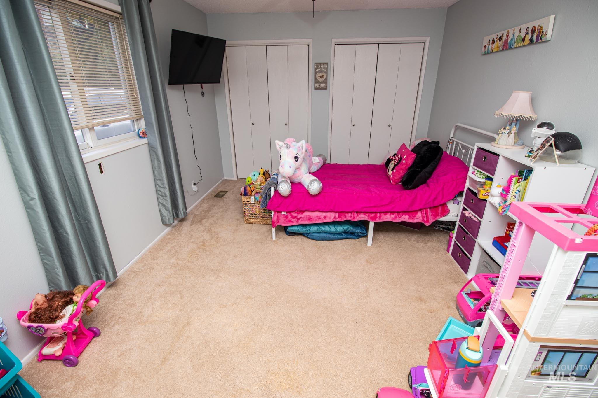 Bedroom with two closets and carpet floors