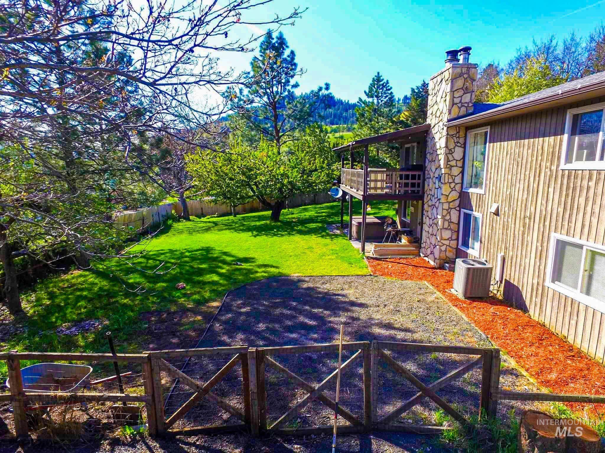 Fenced backyard with a deck