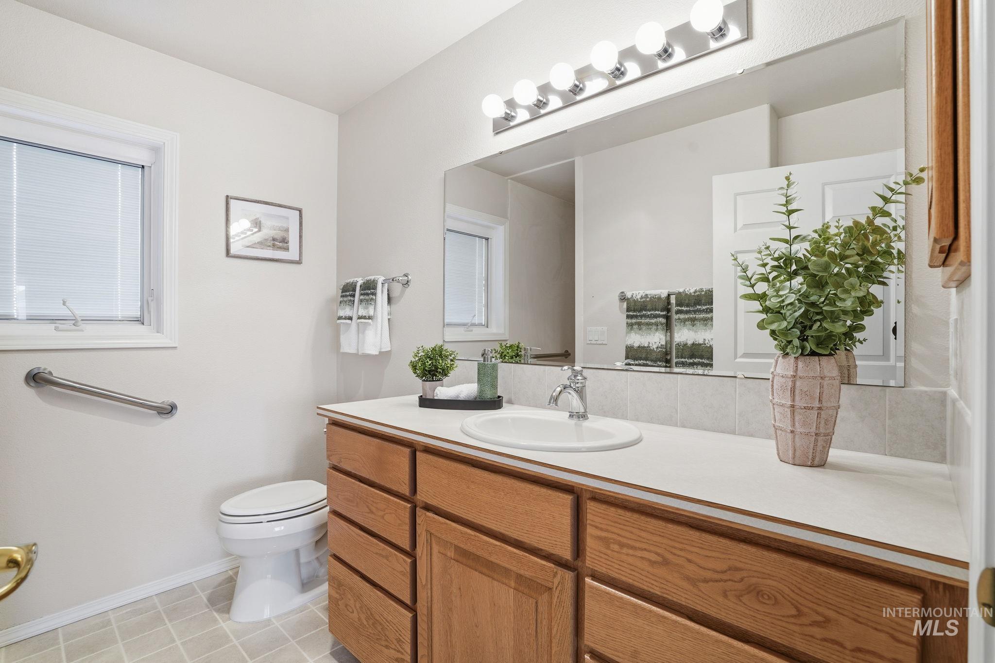 Primary Bathroom with vanity and light tile patterned floors