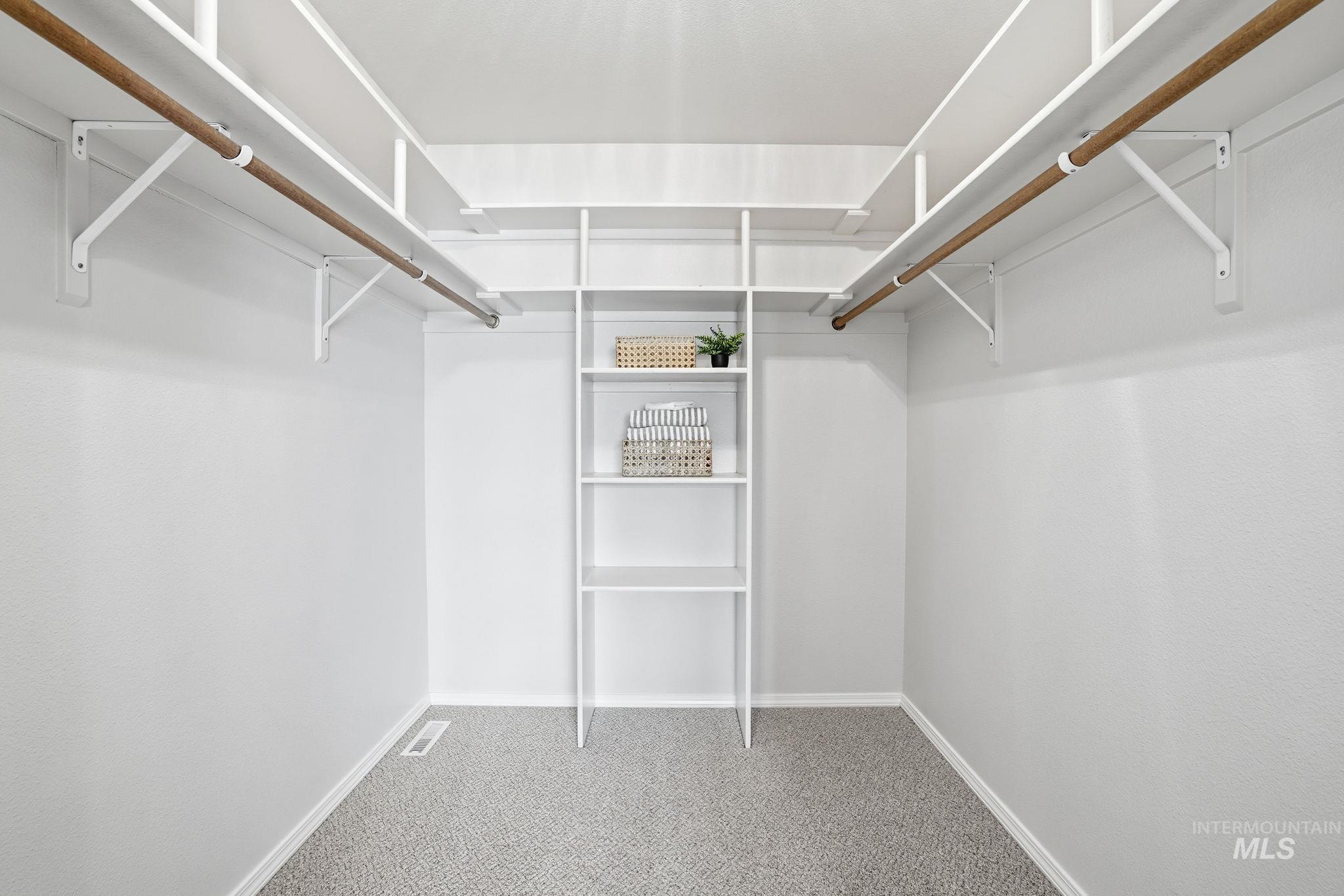 Primary Bedroom Walk-in Spacious closet with light colored carpet