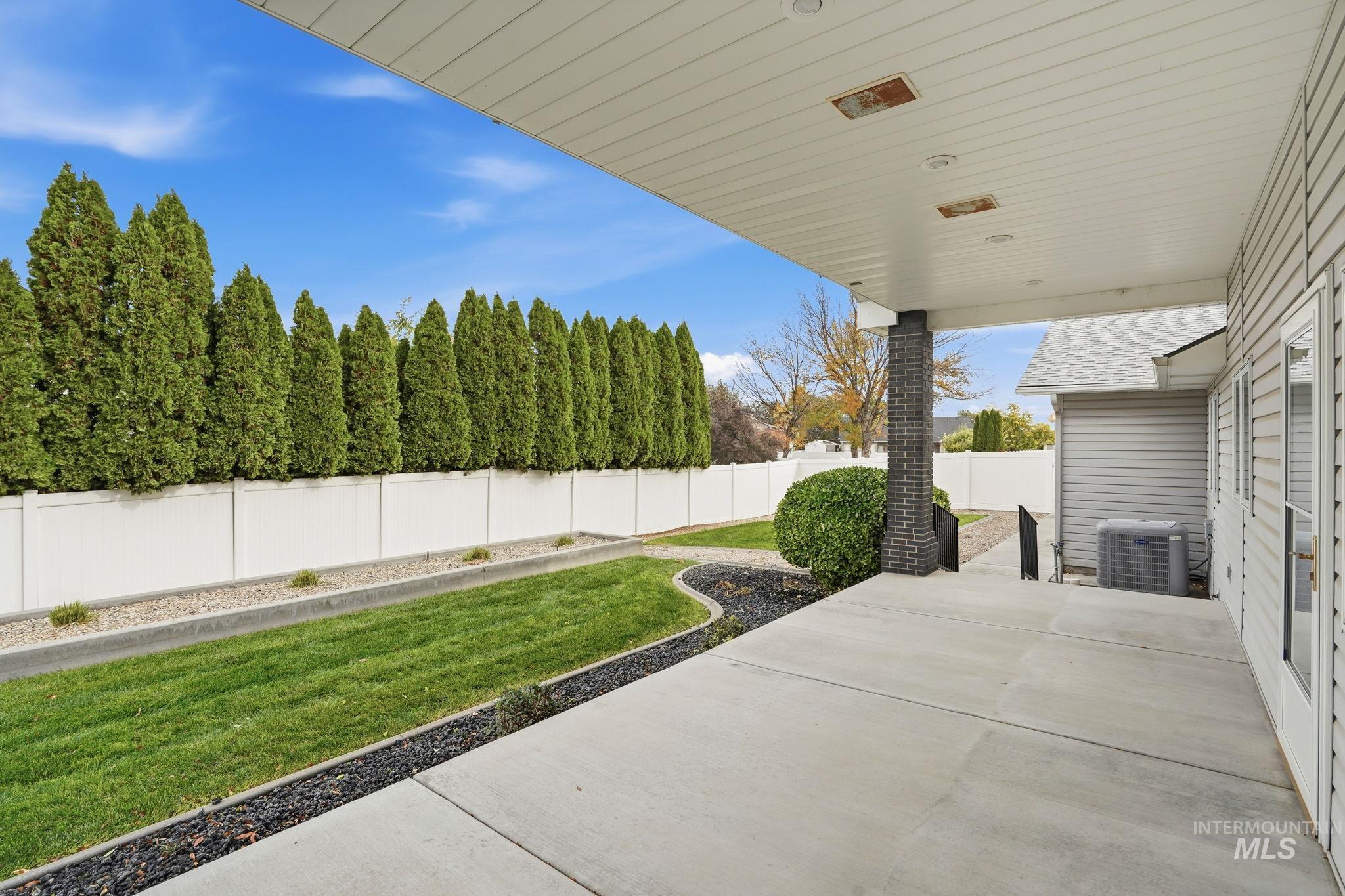 Fenced backyard with a patio