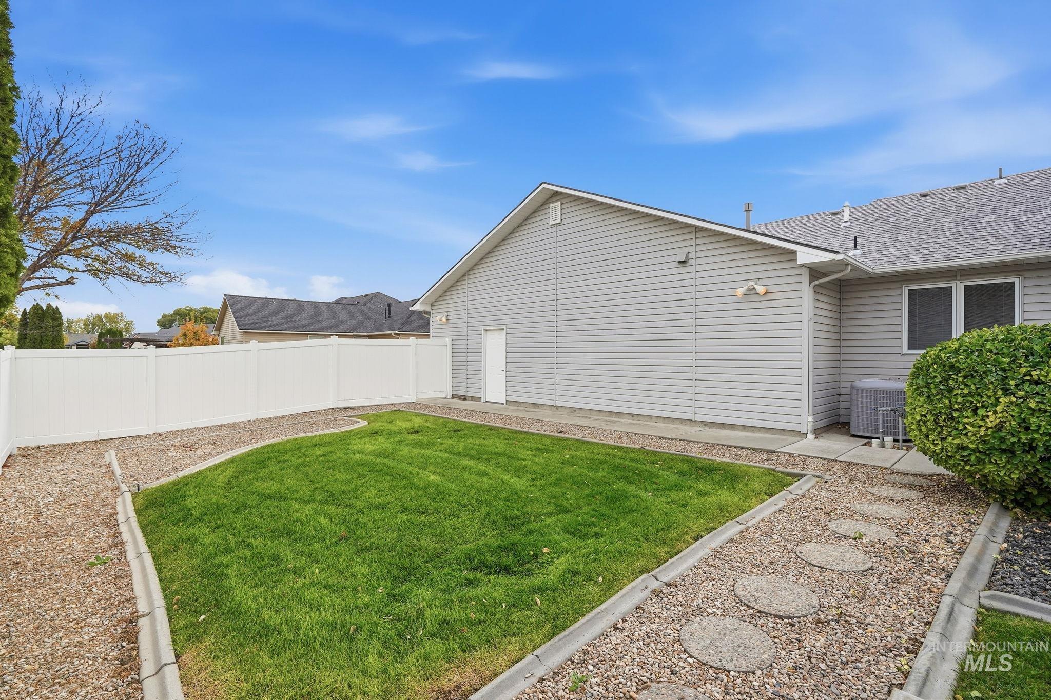 Fenced backyard with a patio