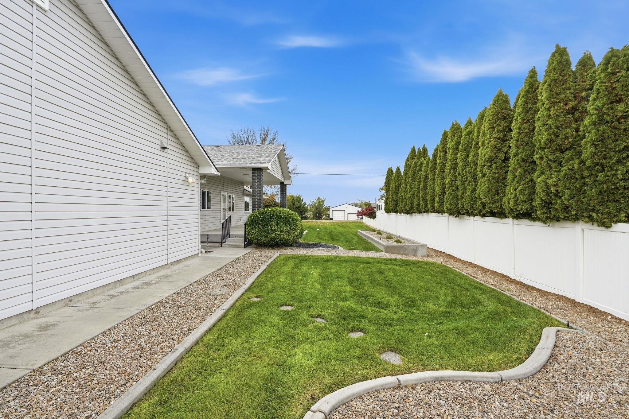 Fenced backyard featuring a porch