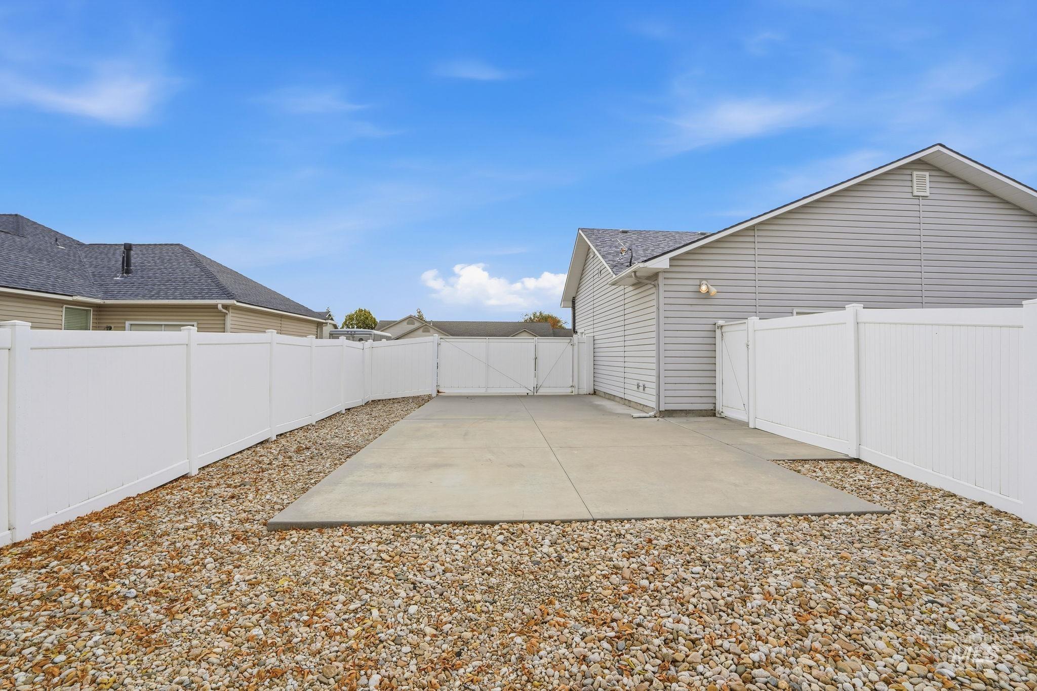 Gated 51x23 RV Parking area with concrete pad and 14-ft rolling gate.