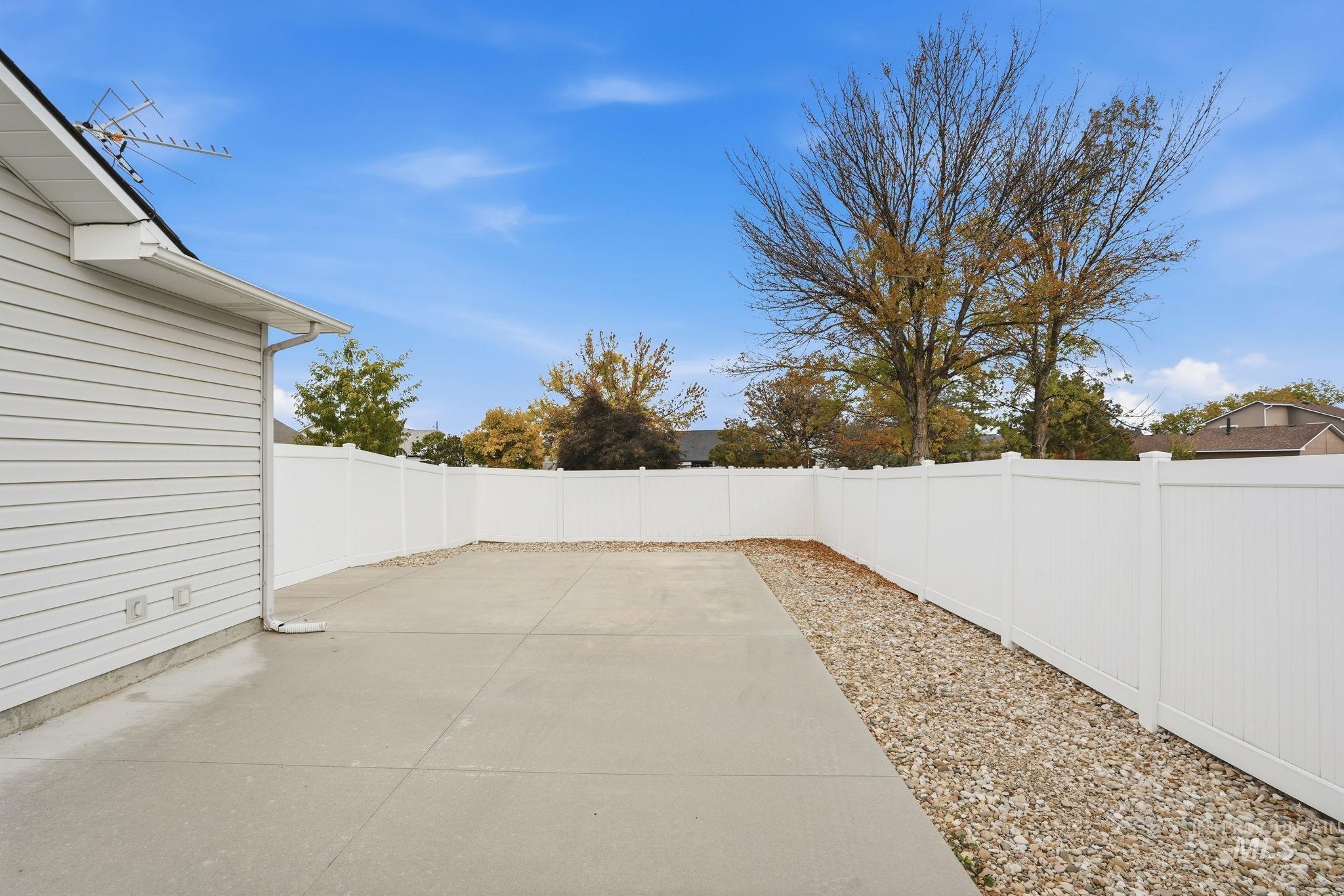 Gated 51x23 RV Parking area with concrete pad and 14-ft rolling gate.