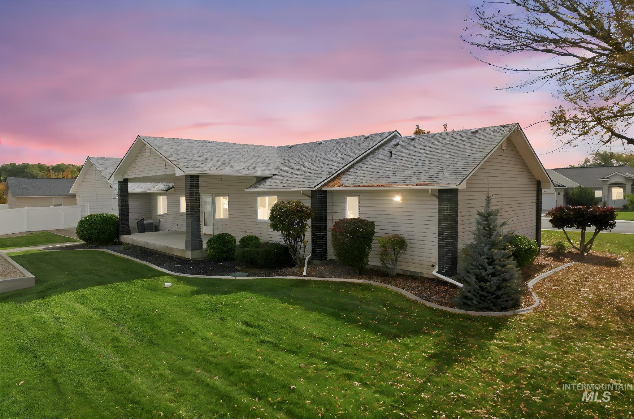 Single story home with a shingled roof and covered porch