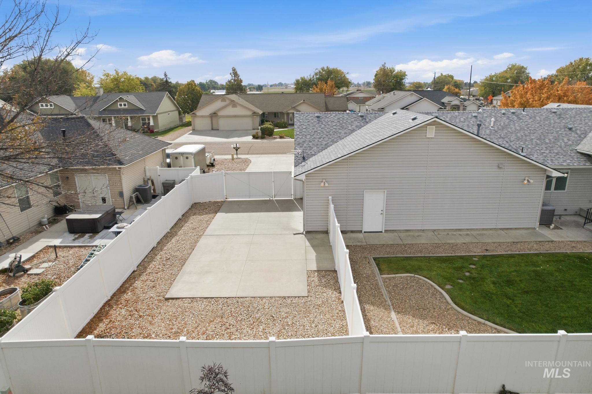 Fenced backyard featuring a residential view and a patio area
